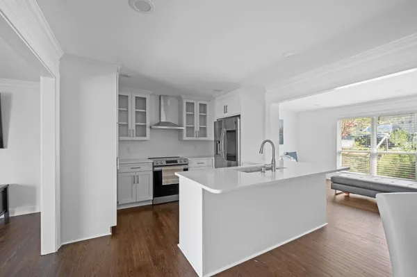 a view of a kitchen with a sink wooden floor and a window