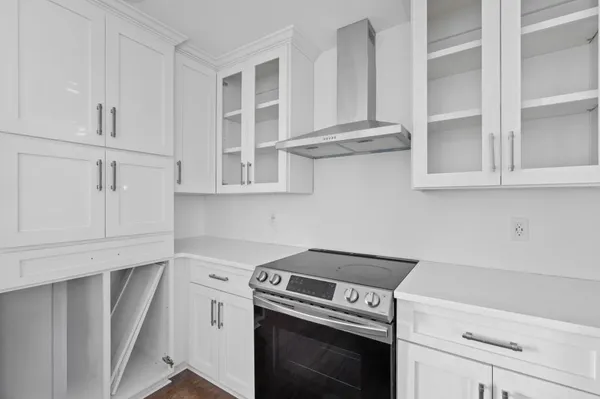 a kitchen with white cabinets and white appliances
