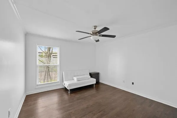 a view of room with hardwood floor and ceiling fan