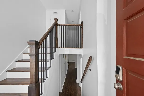 a view of staircase with wooden floor and a window