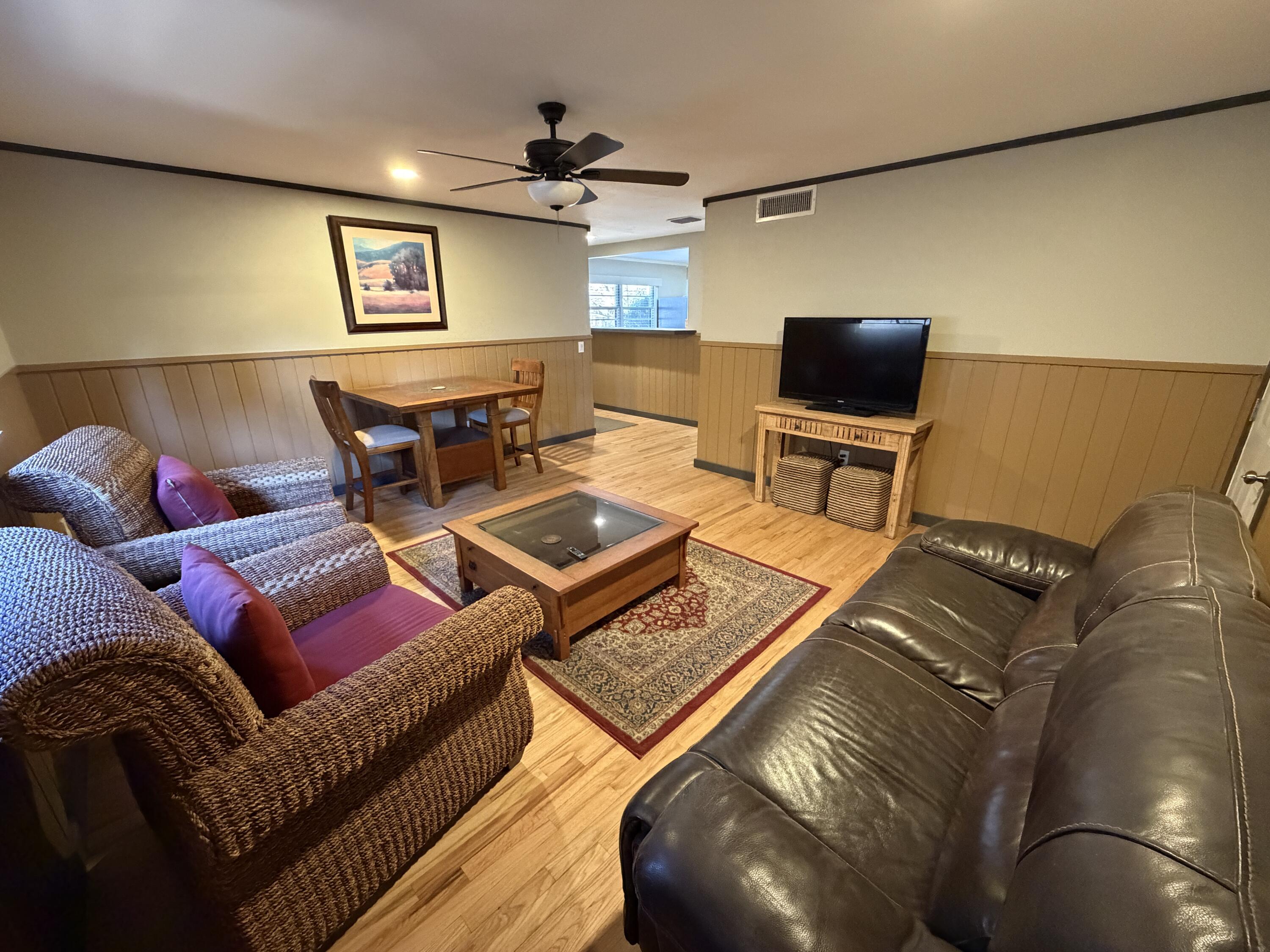3113 38th Street Lubbock, TX 79413 - Photo 11 of 22 a living room with furniture and a flat screen tv