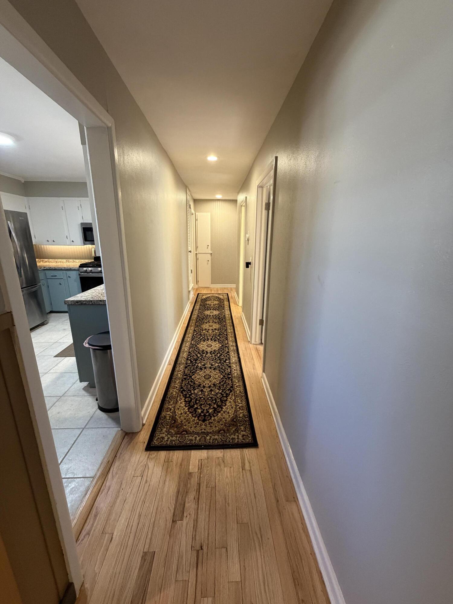 3113 38th Street Lubbock, TX 79413 - Photo 8 of 22 a view of a hallway with wooden floor