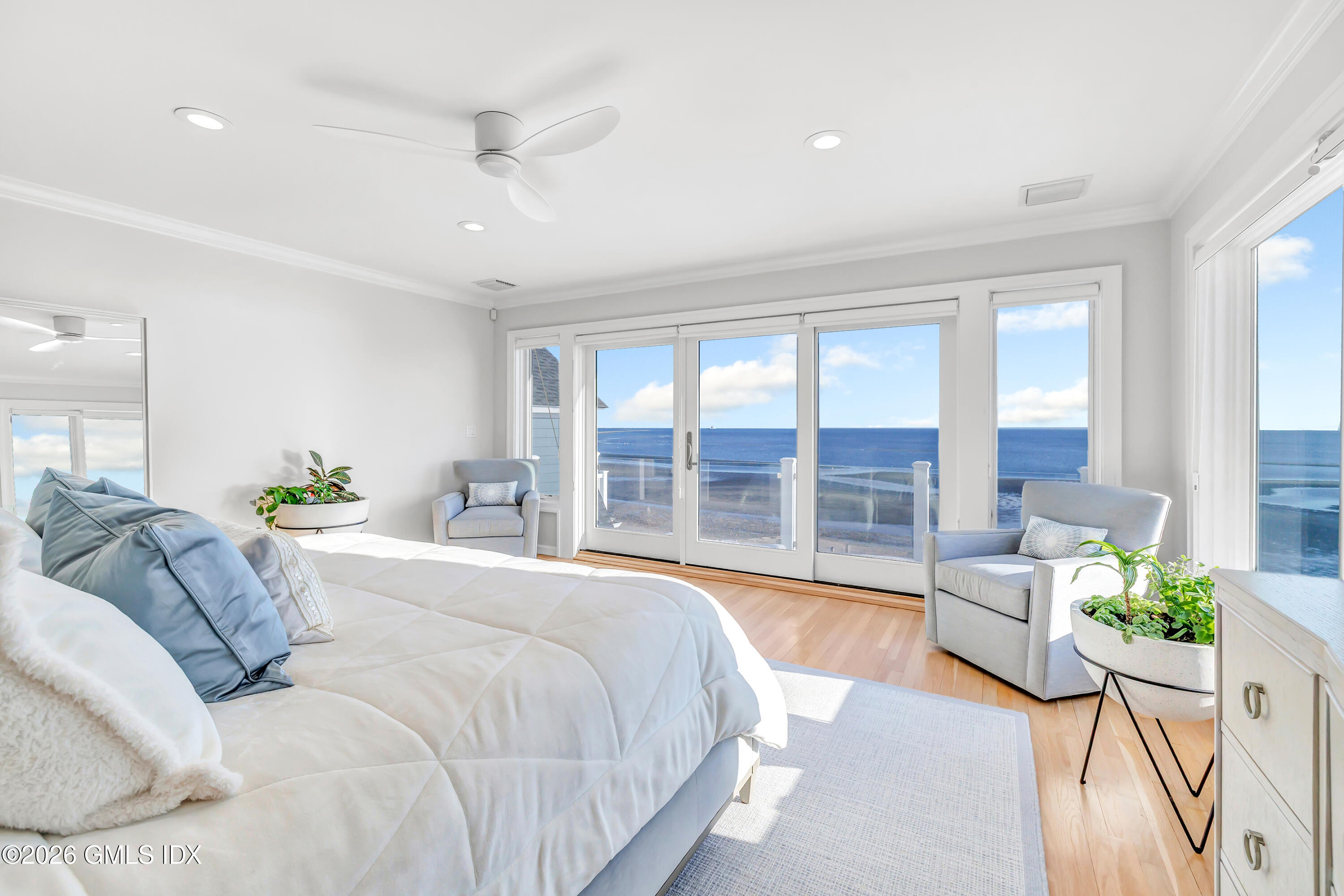 1053 Fairfield Beach Road Fairfield, CT 06824 - Photo 12 of 40 a spacious bedroom with a bed and a large window
