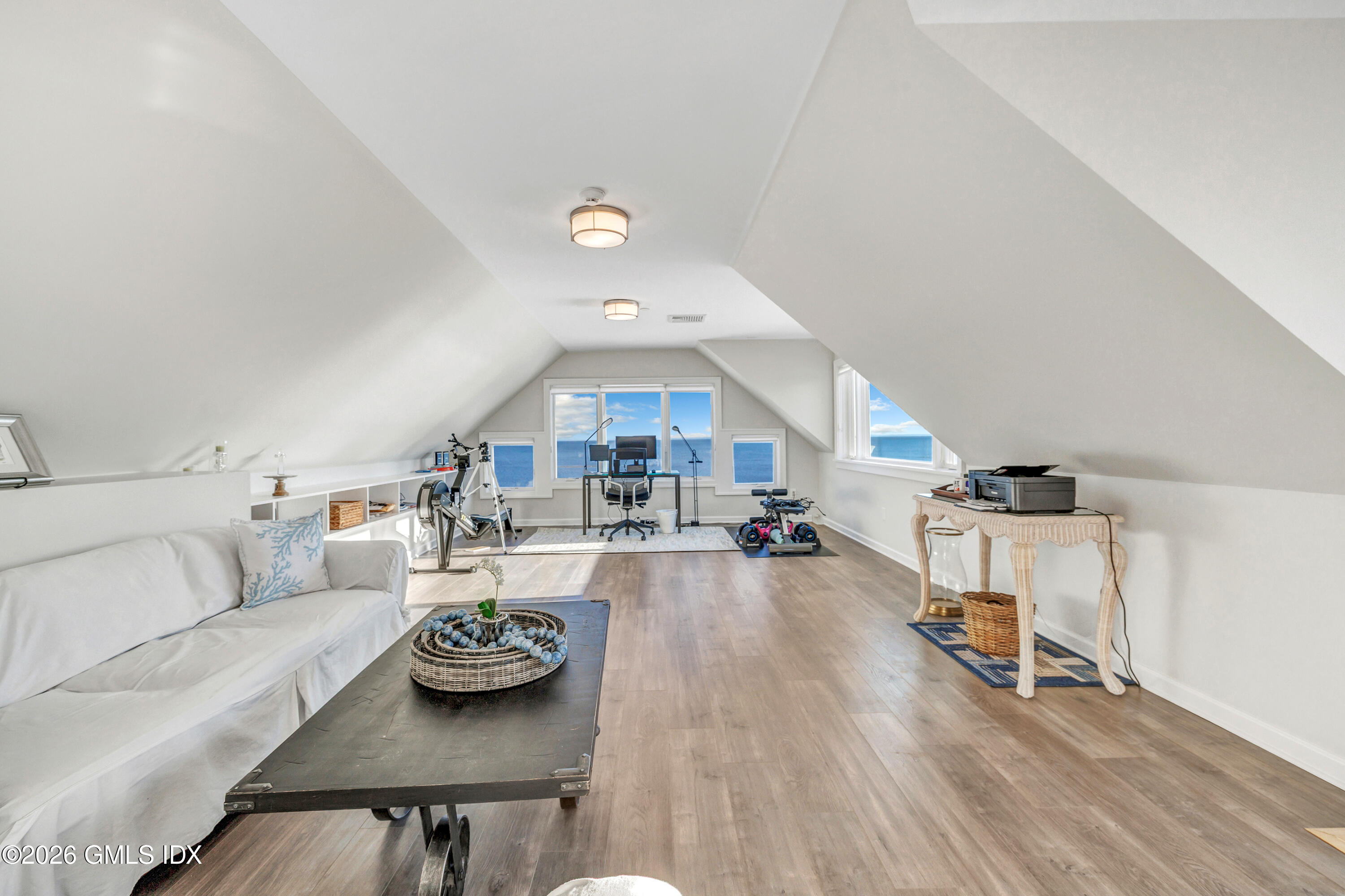1053 Fairfield Beach Road Fairfield, CT 06824 - Photo 20 of 40 a living room with furniture and a wooden floor