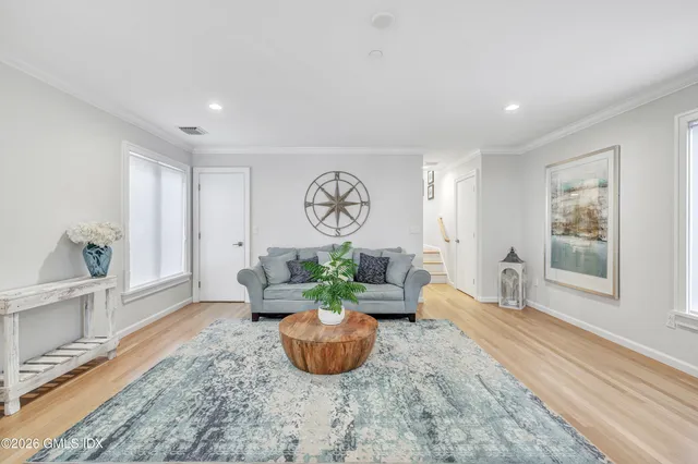 a living room with furniture potted plant and window