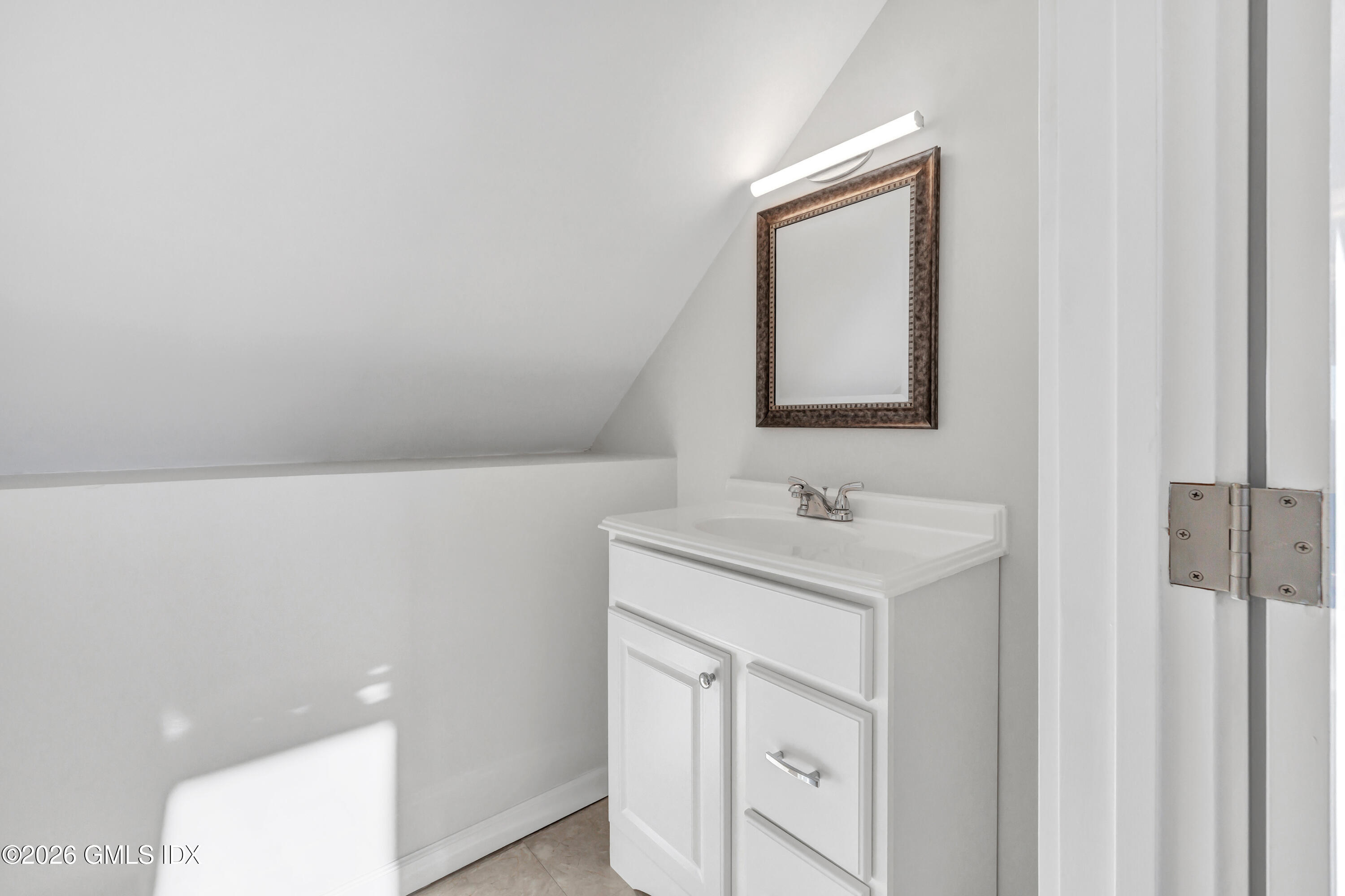 1053 Fairfield Beach Road Fairfield, CT 06824 - Photo 30 of 40 a bathroom with a sink a vanity and a toilet