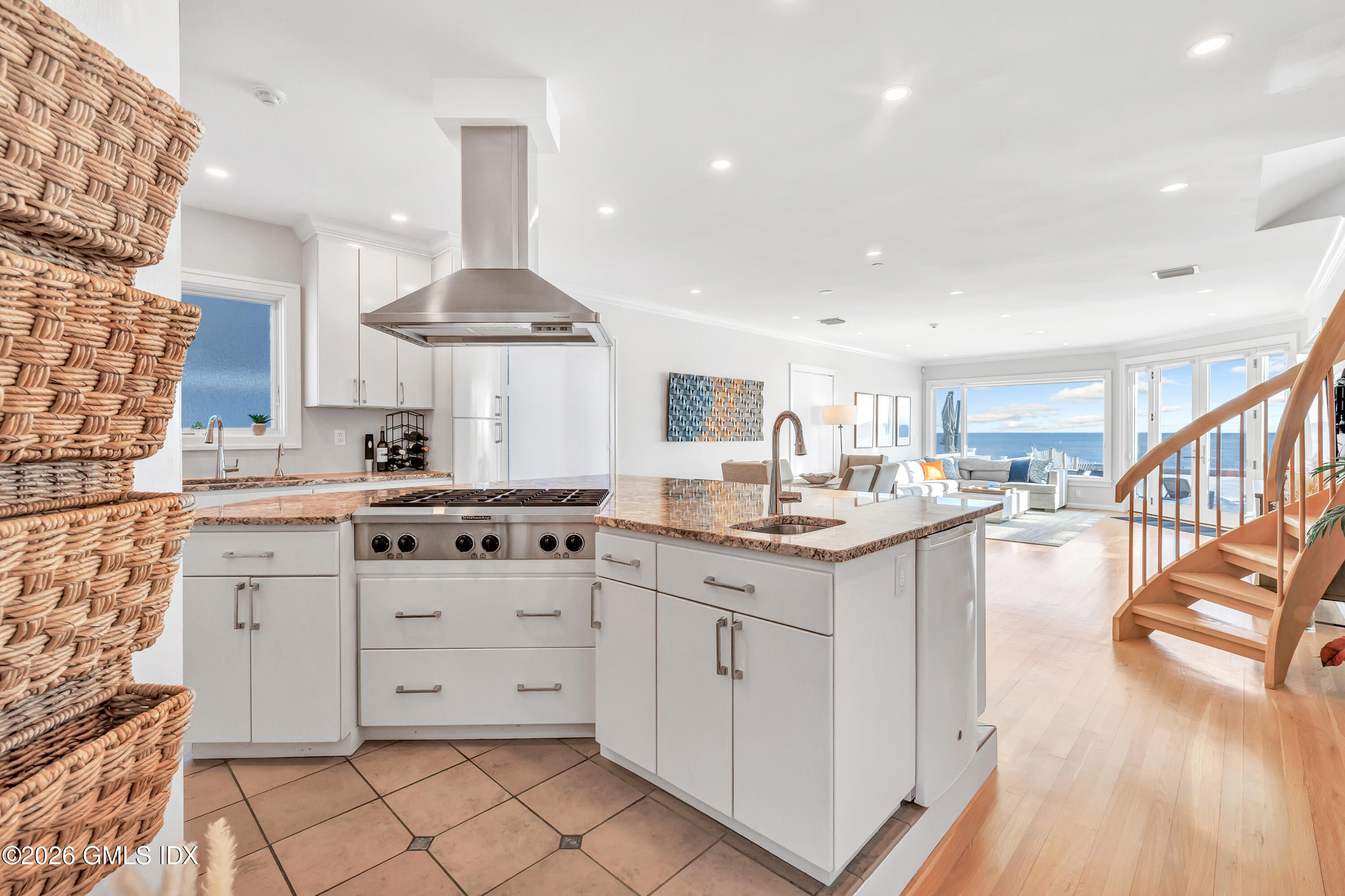 1053 Fairfield Beach Road Fairfield, CT 06824 - Photo 3 of 40 a kitchen with stainless steel appliances a sink stove and cabinets