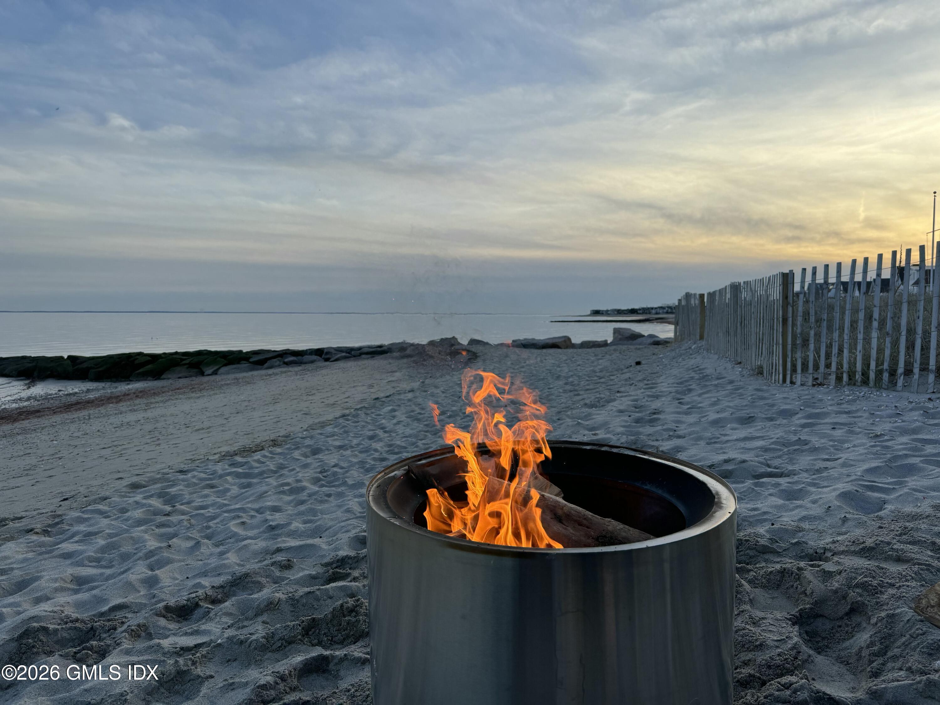 1053 Fairfield Beach Road Fairfield, CT 06824 - Photo 36 of 40 a backyard of a house with table and chairs