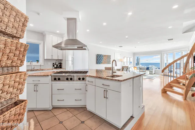 a kitchen with stainless steel appliances a sink stove and cabinets