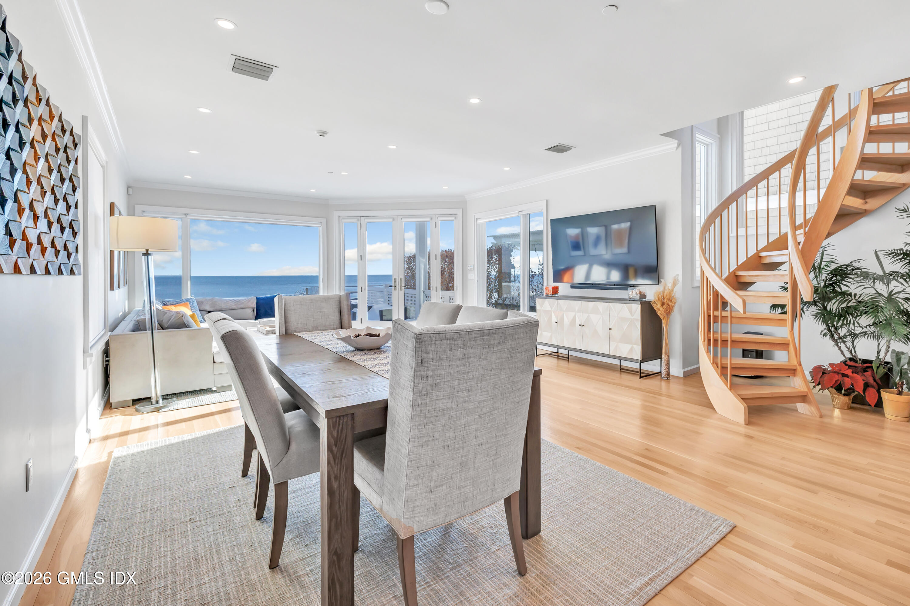 1053 Fairfield Beach Road Fairfield, CT 06824 - Photo 7 of 40 a view of a dining room with furniture and wooden floor