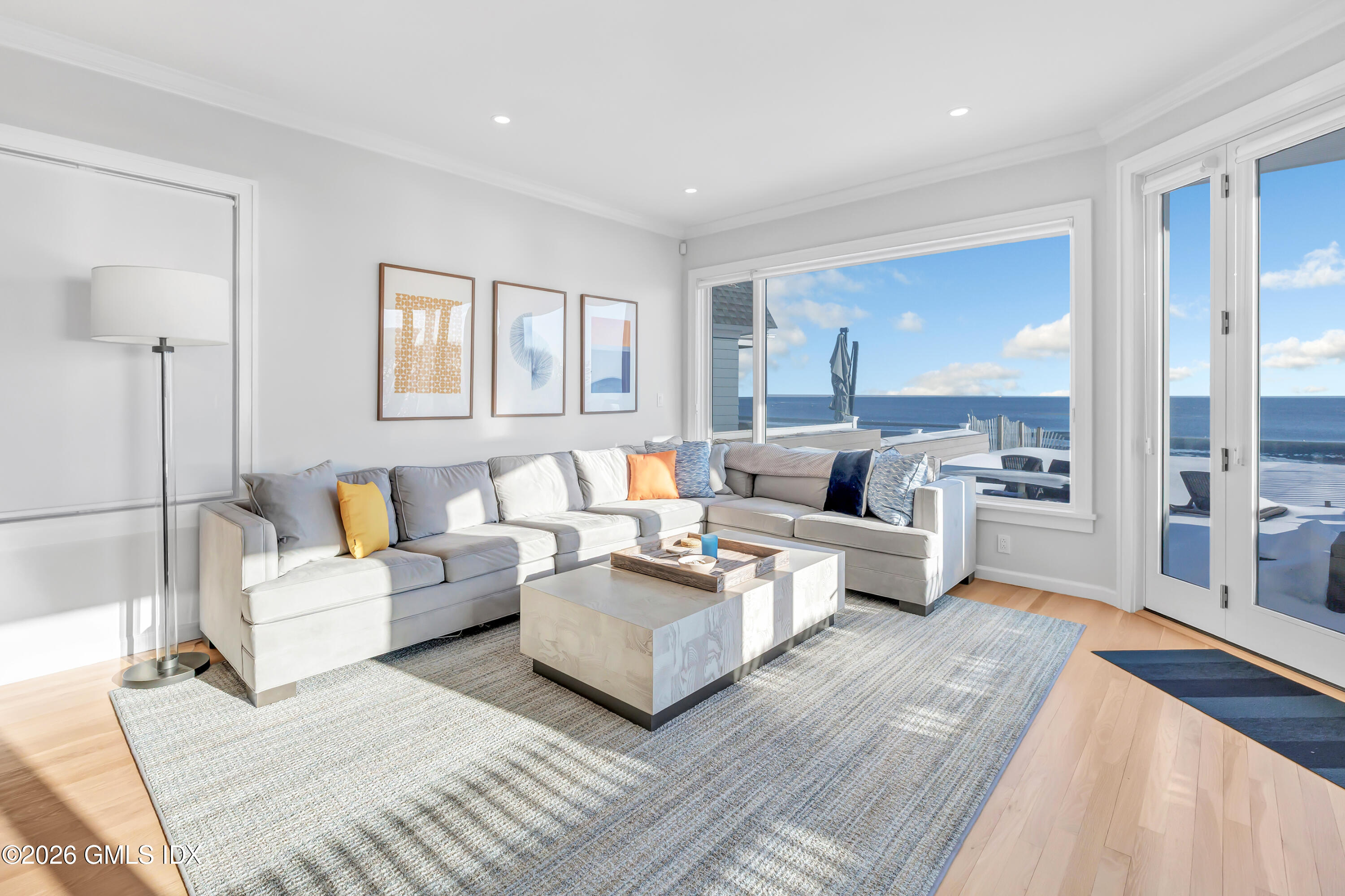 1053 Fairfield Beach Road Fairfield, CT 06824 - Photo 8 of 40 a living room with furniture and a large window