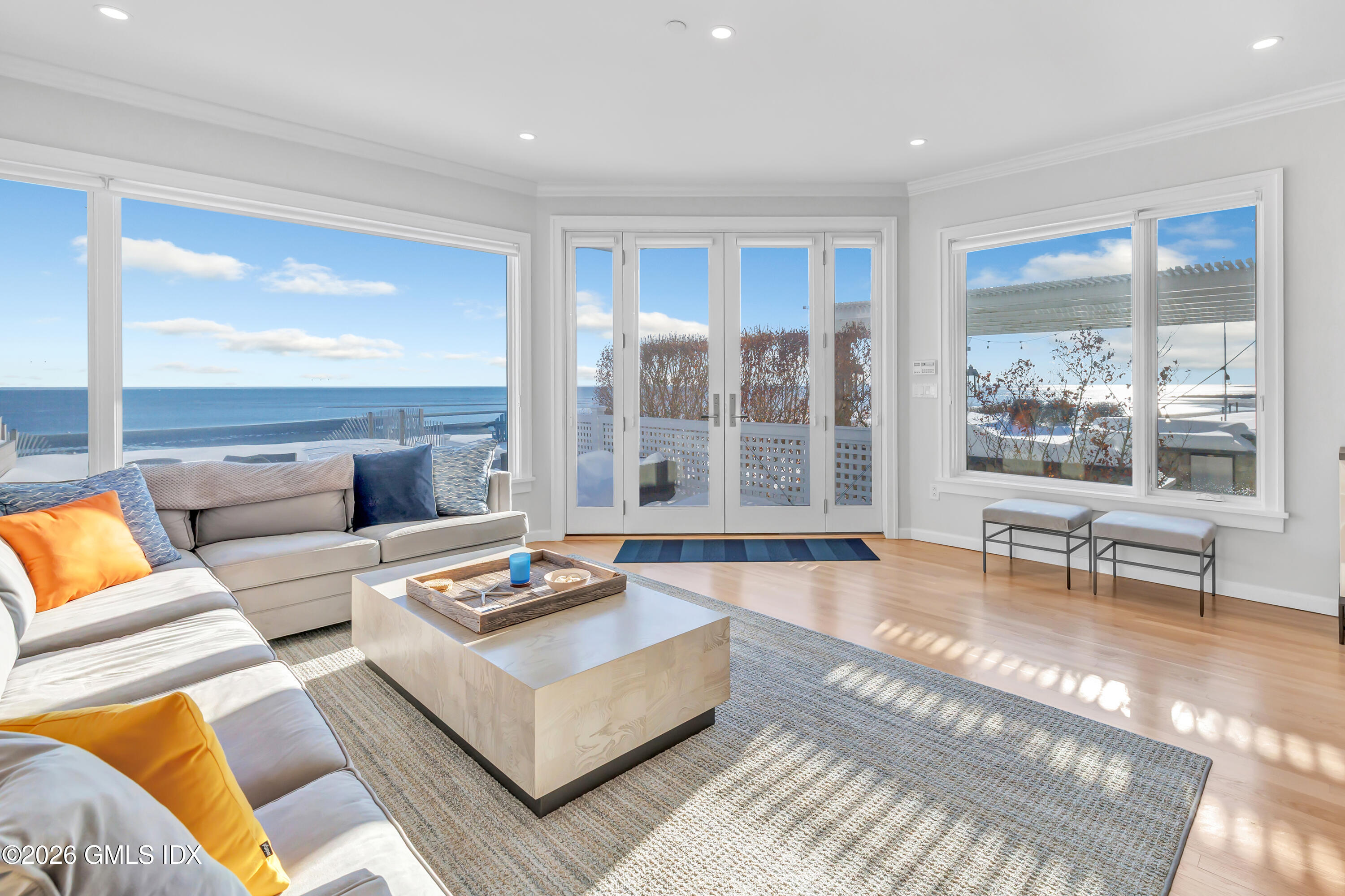 1053 Fairfield Beach Road Fairfield, CT 06824 - Photo 10 of 40 a living room with furniture and a large window