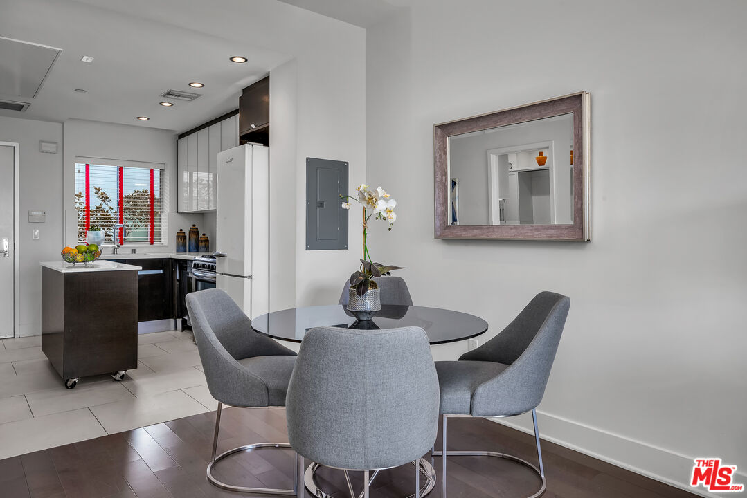 7857 West Manchester Avenue, Unit 201 Playa del Rey, CA 90293 - Photo 14 of 28 a dining room with furniture and window