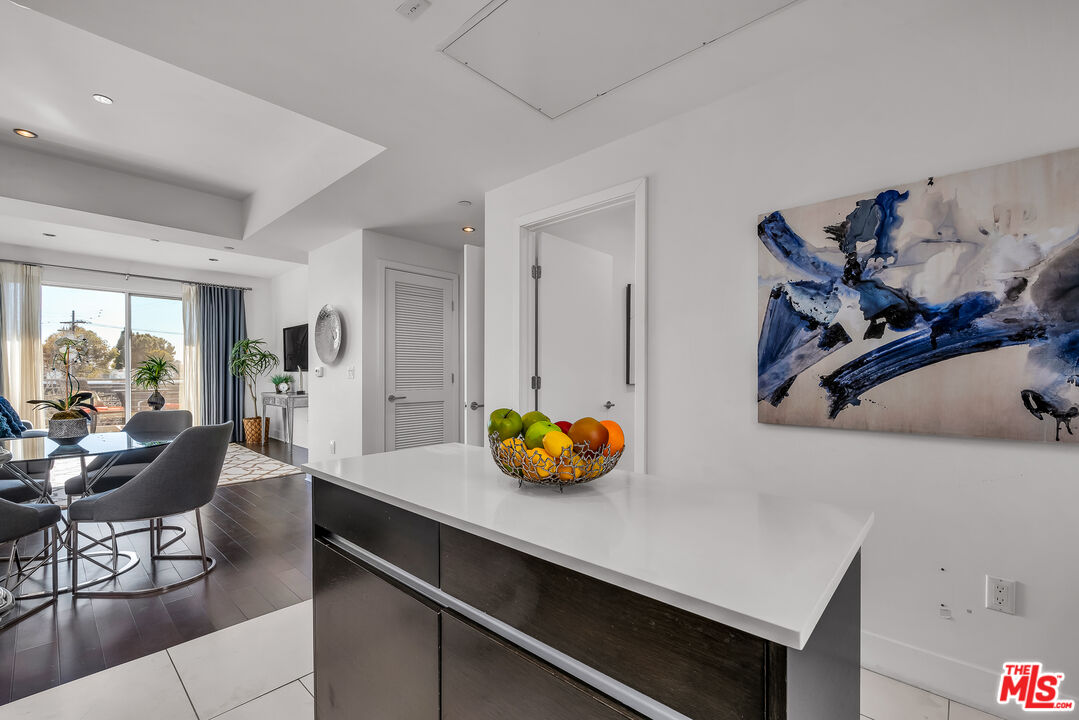 7857 West Manchester Avenue, Unit 201 Playa del Rey, CA 90293 - Photo 17 of 28 a kitchen with stainless steel appliances cabinets and wooden floor