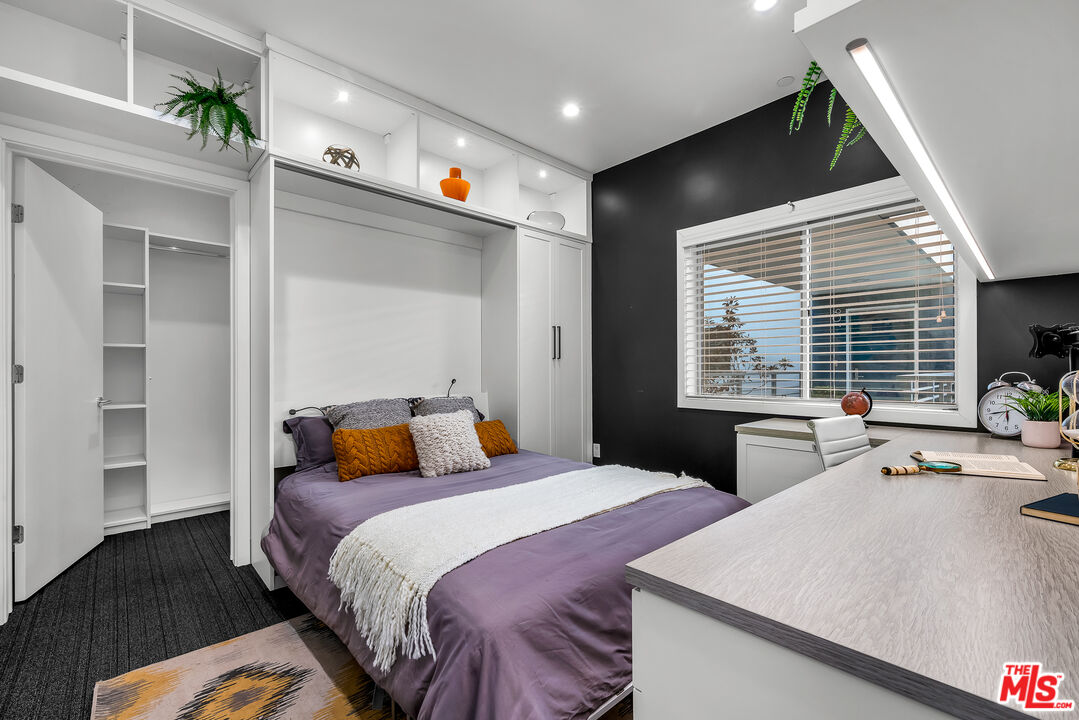 7857 West Manchester Avenue, Unit 201 Playa del Rey, CA 90293 - Photo 21 of 28 a bedroom with a large bed and a large window