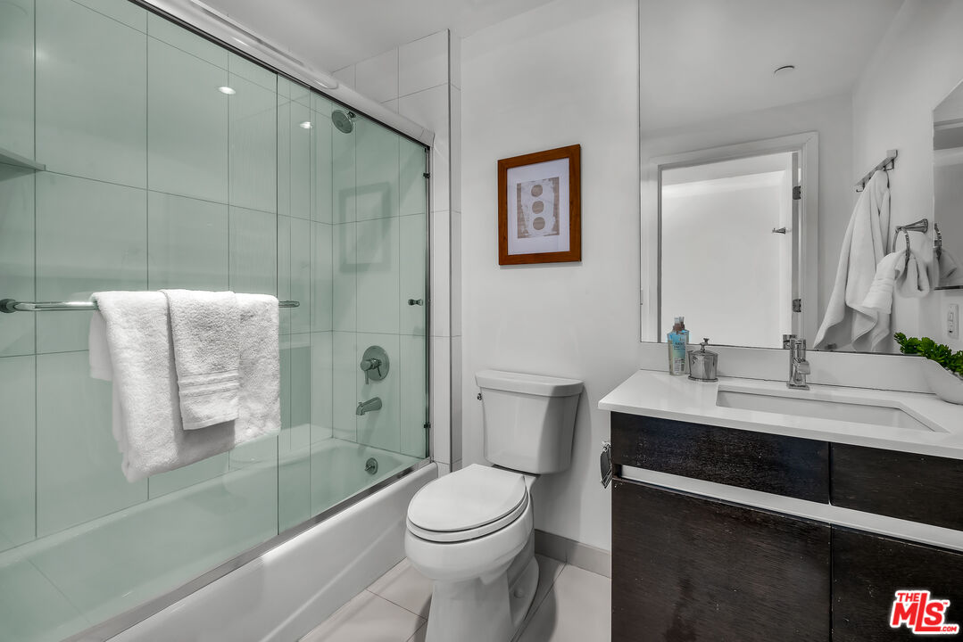 7857 West Manchester Avenue, Unit 201 Playa del Rey, CA 90293 - Photo 24 of 28 a bathroom with a sink a toilet and shower
