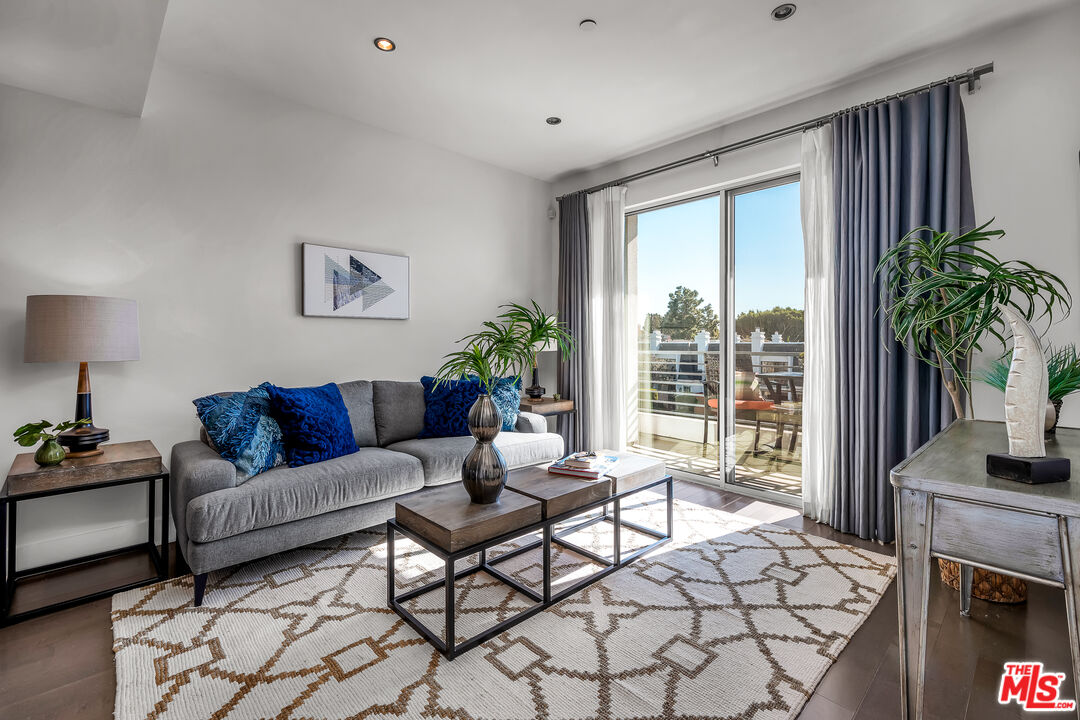 7857 West Manchester Avenue, Unit 201 Playa del Rey, CA 90293 - Photo 6 of 28 a living room with furniture a flat screen tv and a large window