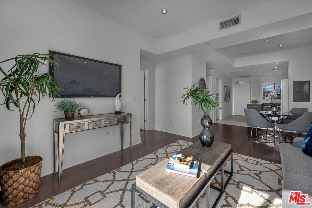 7857 West Manchester Avenue, Unit 201 Playa del Rey, CA 90293 - Photo 7 of 28 a living room with furniture and a flat screen tv