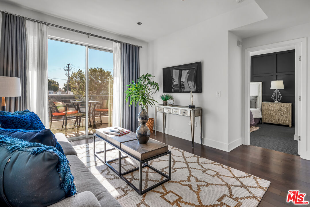 7857 West Manchester Avenue, Unit 201 Playa del Rey, CA 90293 - Photo 8 of 28 a living room with furniture and a flat screen tv