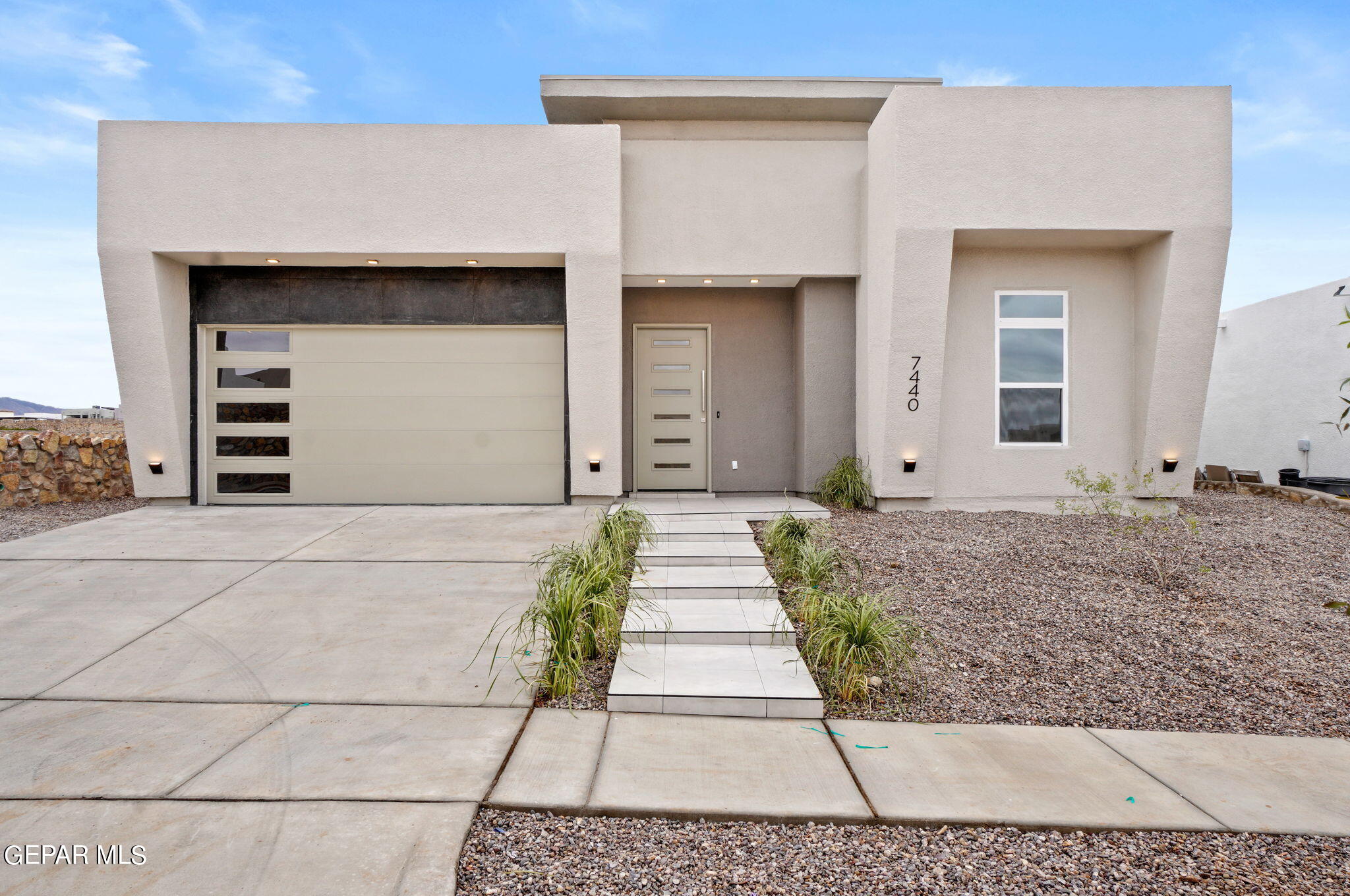 7440 Cimarron Rim Road El Paso, TX 79911 - Photo 1 of 1 a front view of a house with a garden