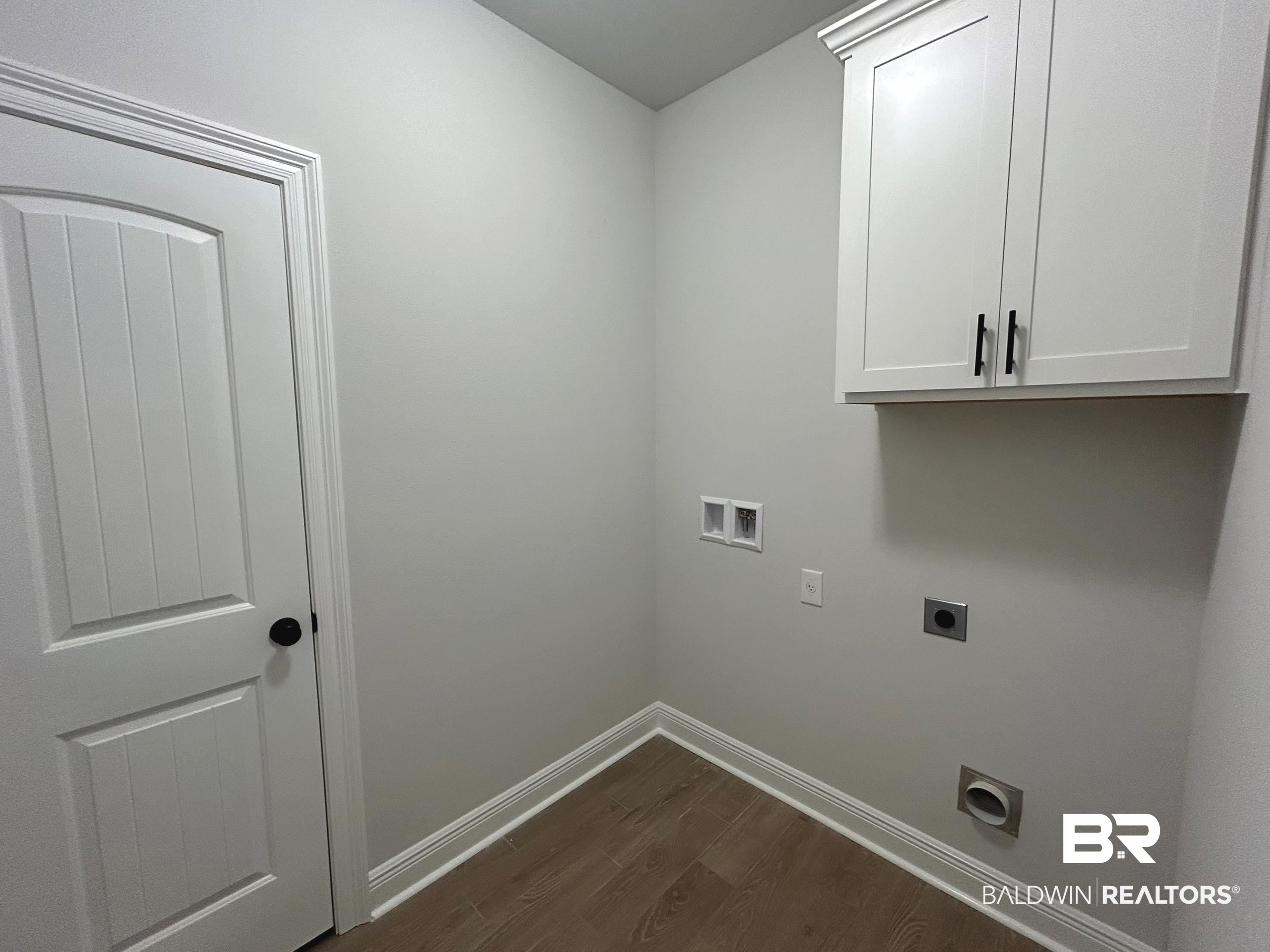 860 Sumter Loop Foley, AL 36535 - Photo 21 of 26 Laundry room featuring hookup for a washing machine, dark wood-type flooring, electric dryer hookup, and cabinets