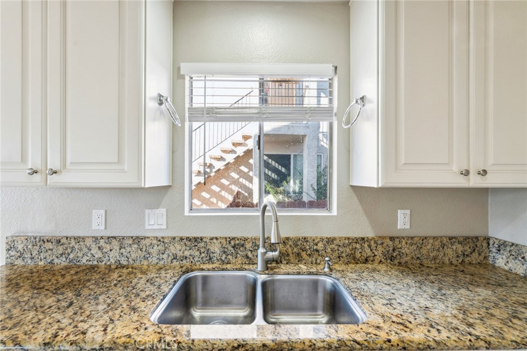 34602 Calle Rosita, Unit A Dana Point, CA 92624 - Photo 11 of 27 a kitchen with granite countertop a sink and a window