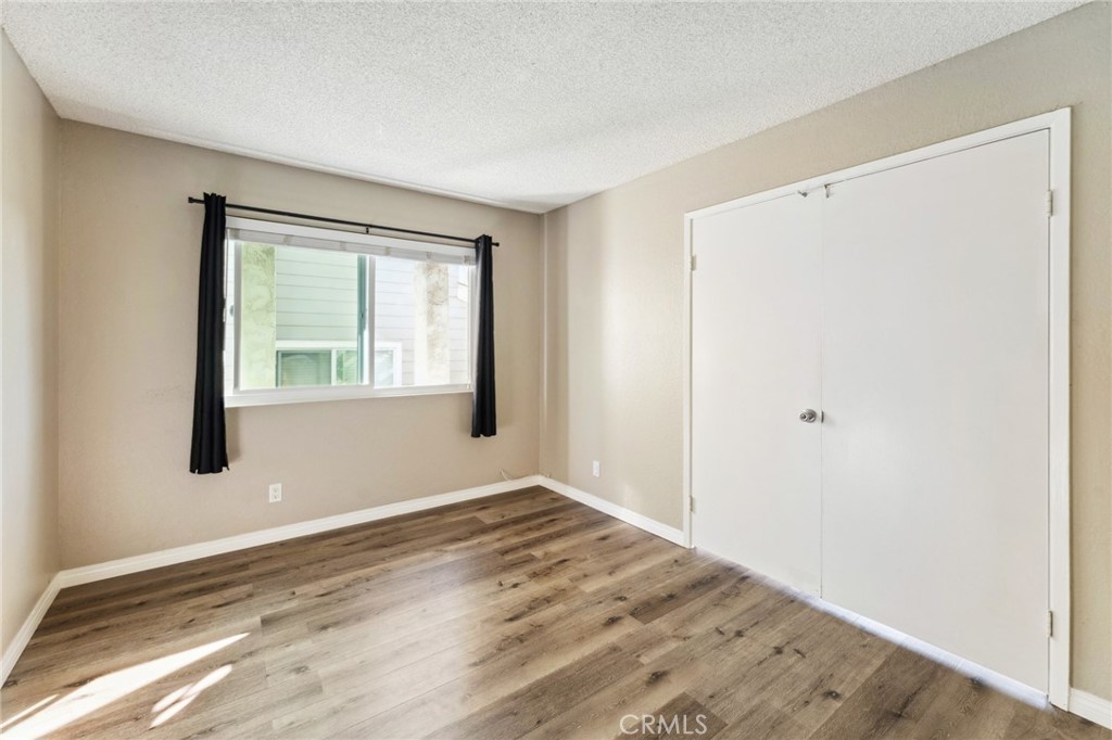 34602 Calle Rosita, Unit A Dana Point, CA 92624 - Photo 14 of 27 a view of an empty room with wooden floor and a window