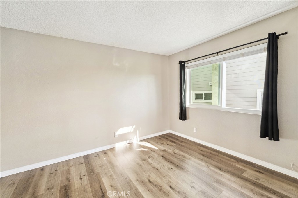 34602 Calle Rosita, Unit A Dana Point, CA 92624 - Photo 16 of 27 a view of empty room with wooden floor and fan