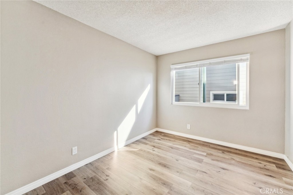 34602 Calle Rosita, Unit A Dana Point, CA 92624 - Photo 17 of 27 a view of an empty room with wooden floor and a window