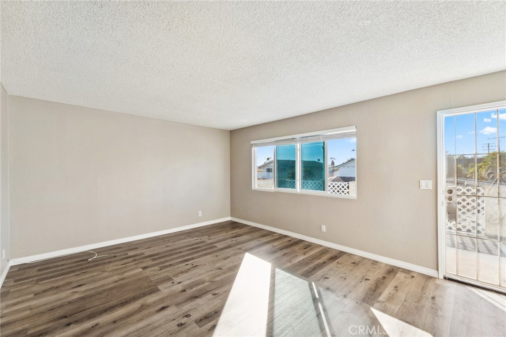 34602 Calle Rosita, Unit A Dana Point, CA 92624 - Photo 4 of 27 a view of an empty room with wooden floor and a window