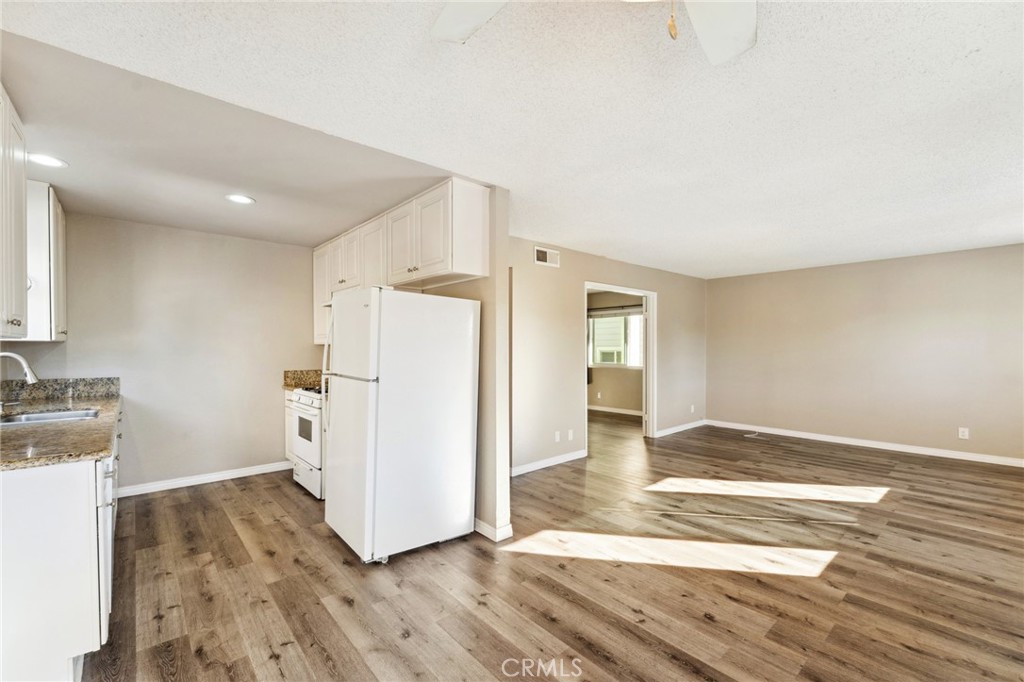 34602 Calle Rosita, Unit A Dana Point, CA 92624 - Photo 6 of 27 a view of a kitchen with a sink and a refrigerator