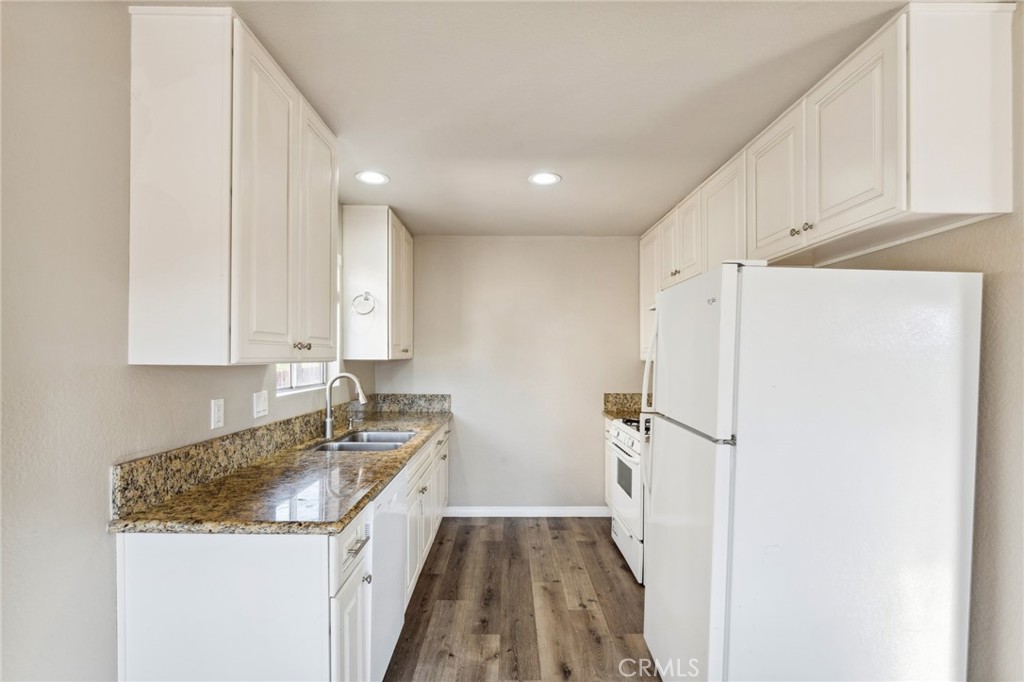 34602 Calle Rosita, Unit A Dana Point, CA 92624 - Photo 10 of 27 a kitchen with granite countertop white cabinets and refrigerator