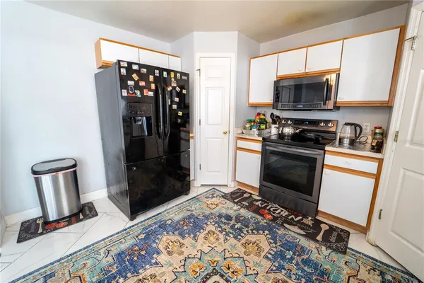 a kitchen with stainless steel appliances granite countertop a refrigerator stove and sink