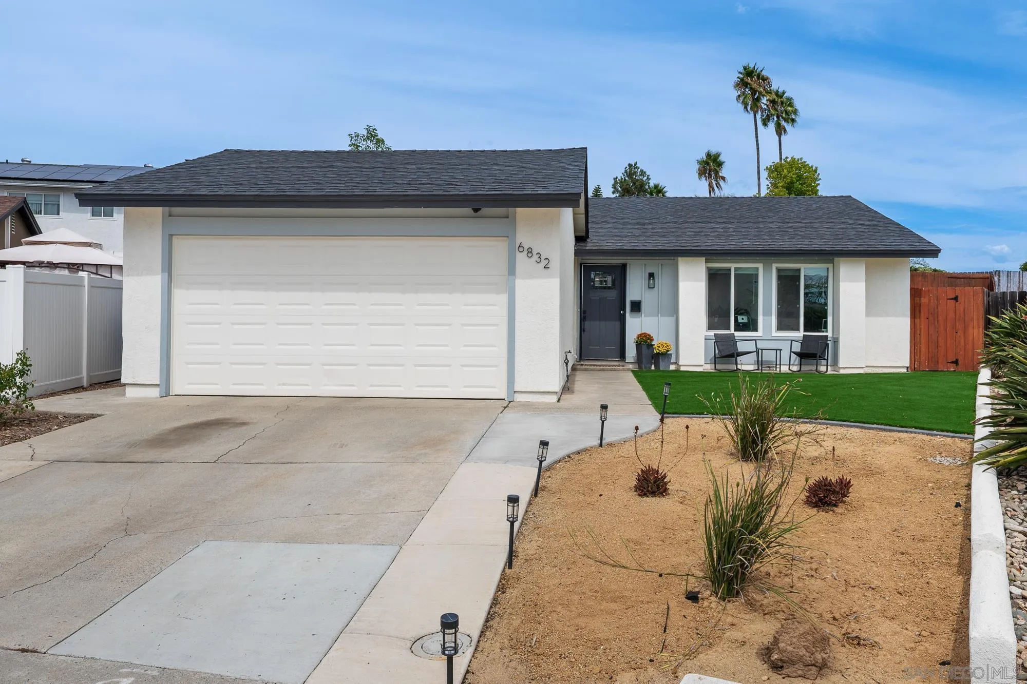 6832 Lazy Clouds San Diego, CA 92120 - Photo 1 of 45 a front view of a house with a yard and garage