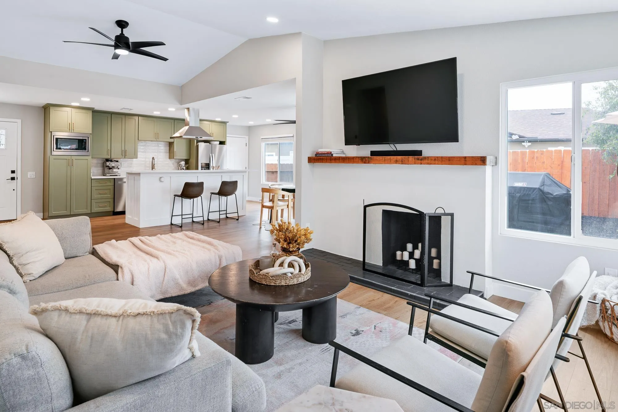 6832 Lazy Clouds San Diego, CA 92120 - Photo 12 of 45 a living room with furniture a flat screen tv and a fireplace