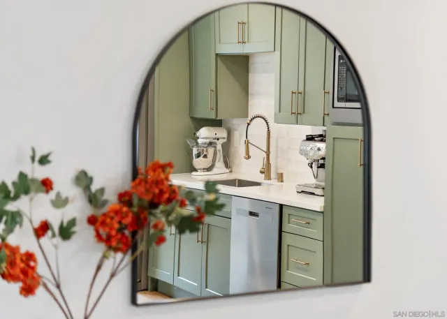 a bathroom with mirror and sink