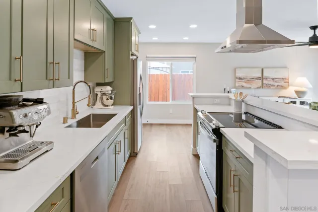 a kitchen with a sink stove top oven and cabinets