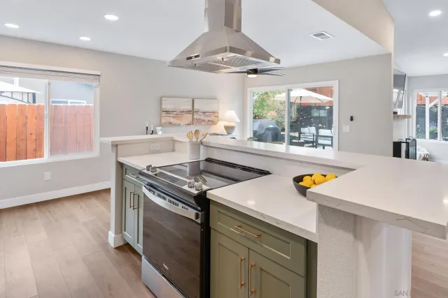 a kitchen with a sink a stove and chairs