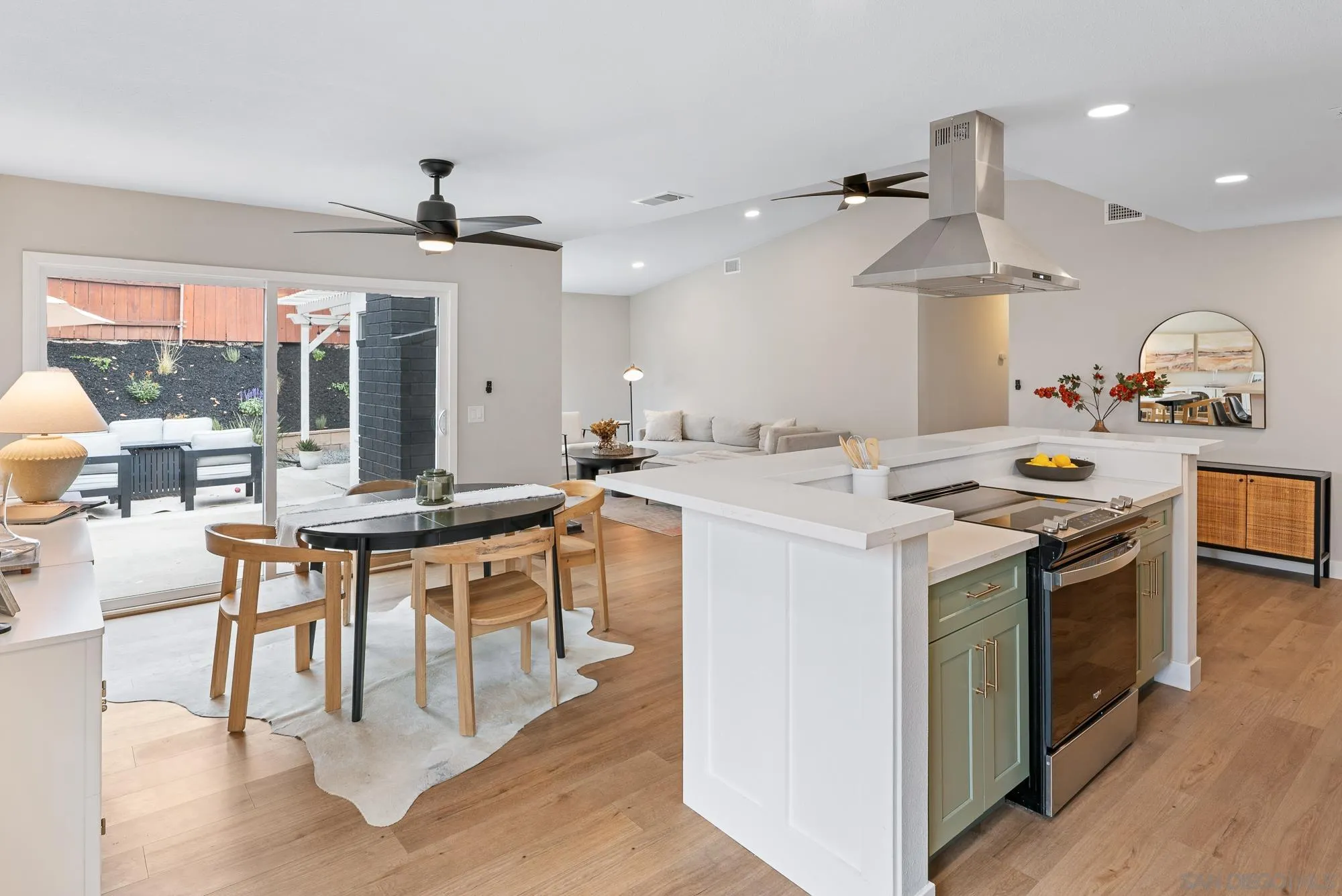 6832 Lazy Clouds San Diego, CA 92120 - Photo 20 of 45 a kitchen with a stove a chandelier and wooden floor