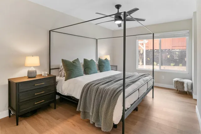 a bedroom with a bed and large window