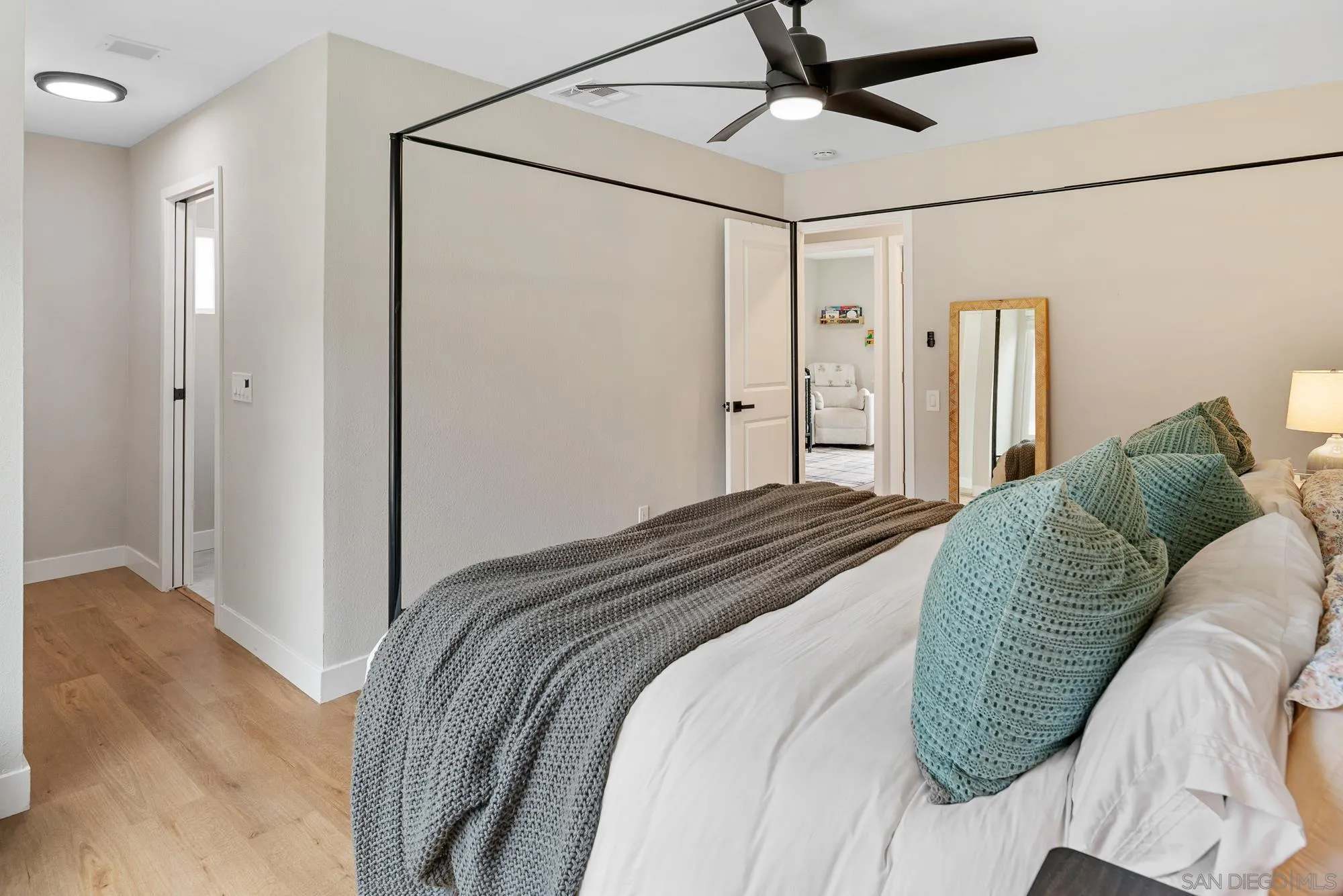 6832 Lazy Clouds San Diego, CA 92120 - Photo 22 of 45 a bedroom with a bed and a chandelier