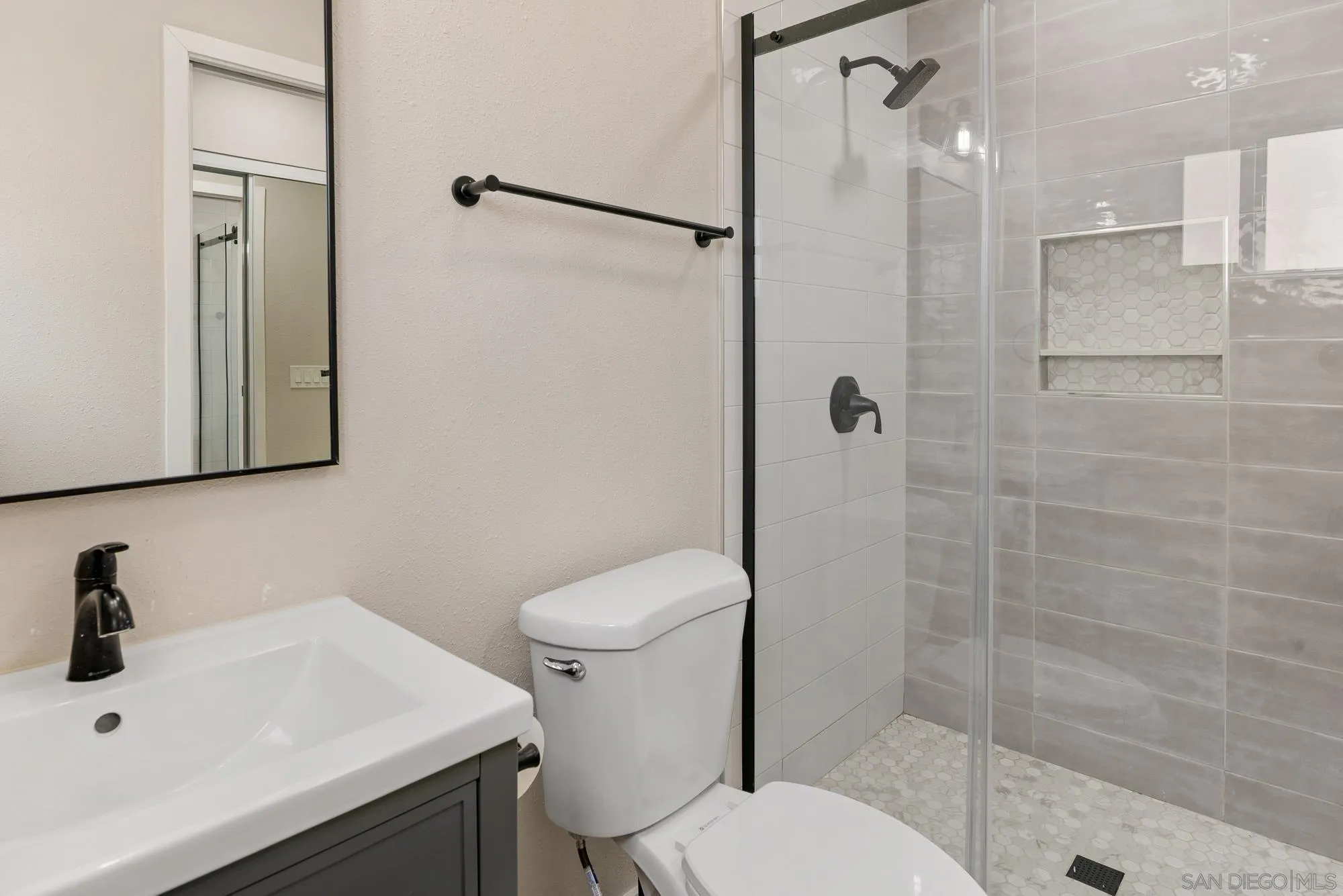 6832 Lazy Clouds San Diego, CA 92120 - Photo 24 of 45 a bathroom with a sink toilet and shower