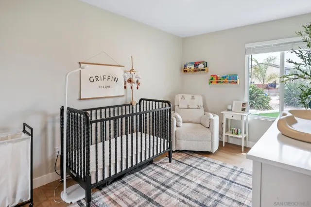 a bedroom with furniture and a large window