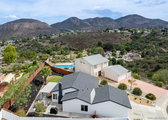an aerial view of a house with a swimming pool