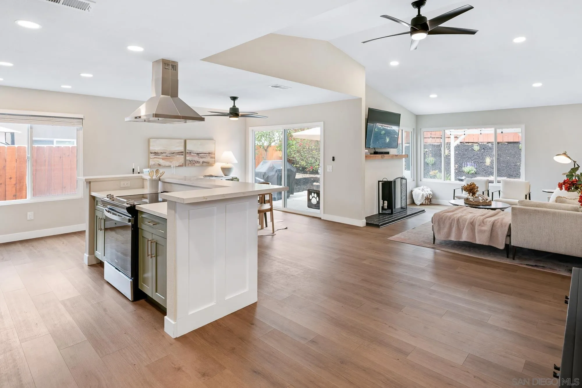 6832 Lazy Clouds San Diego, CA 92120 - Photo 7 of 45 a living room with stainless steel appliances kitchen island hardwood floor and a view of living room