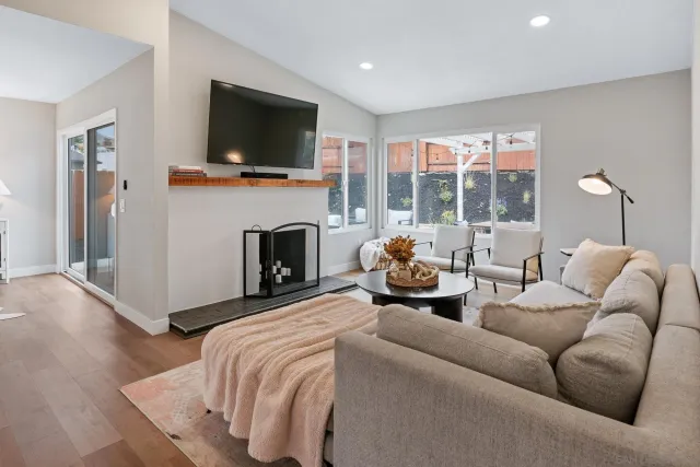 a living room with furniture fireplace and a flat screen tv
