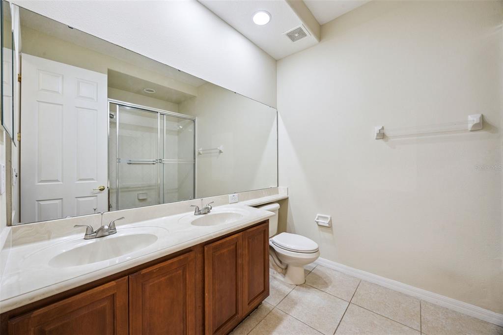 551 Terrace Spring Drive Orlando, FL 32828 - Photo 15 of 41 a bathroom with a double vanity sink toilet and a mirror