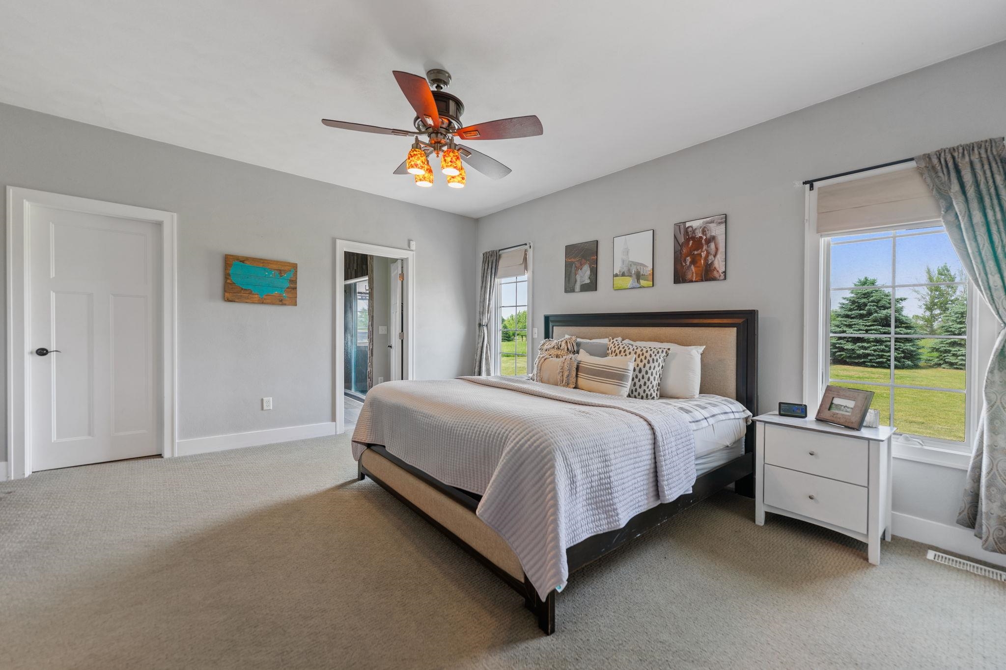 3535 North Keith Road Pecatonica, IL 61063 - Photo 13 of 47 a spacious bedroom with a bed a couch and a window