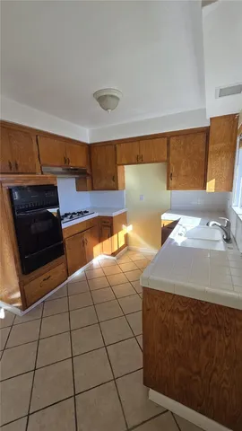 a kitchen with stainless steel appliances a sink and a stove