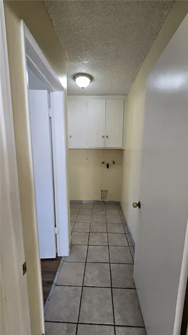 a view of a kitchen with white cabinets
